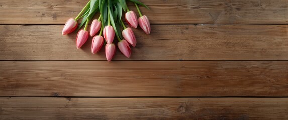 Tulip flowers set against rustic wood background