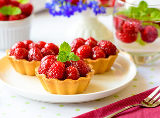 Raspberry mini tart (cupcakes ) on a table