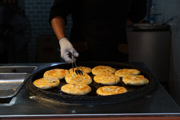 Chef hands preparing Asian street food at local market, authentic travel cuisine and cultural street cooking experience