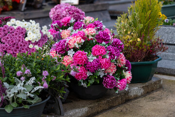 Gros bouquets de fleurs fraiches et multicolore d&eacute;pos&eacute;s sur les tombes dans cimeti&egrave;re &agrave; l'occasion de la Toussaint. France. Cela rend hommage au d&eacute;funt et t&eacute;moigne de l'attachement et du respect.