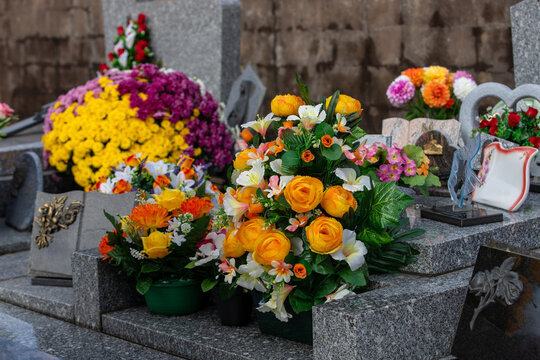 Gros bouquets de fleurs fraiches et multicolore d&eacute;pos&eacute;s sur les tombes dans cimeti&egrave;re &agrave; l'occasion de la Toussaint. France. Cela rend hommage au d&eacute;funt et t&eacute;moigne de l'attachement et du respect.