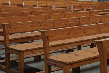 Rows of empty wooden pews inside a church. Mass, Christian religion