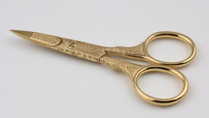 Close up of ornate gold scissors isolated on a white background