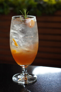 front view ice plum soda in a glass on a marble toth, decorated with plums and branches, nature background, food, drink, object, decor, copy space