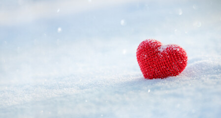 Red heart on white snow for Valentine love day background. Beautiful greeting card or banner.