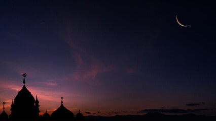 Fototapeta premium Crescent moon on twilight sky after sundown over dome Mosques, Religiuous Islam, Space for text Ramadan Kareem, Eid Mubarak, Eid al-Adha, Eid al-Fitr