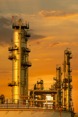 Fototapeta premium Industrial petroleum refinery plant featuring chemical production towers and pipelines under a dramatic powerful sky with glowing energy technology and steam