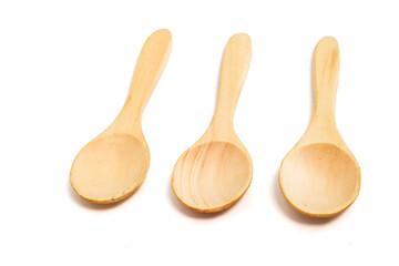 Three wooden spoons isolated on white background, natural material kitchenware