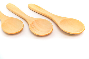 Three Wooden Spoons Lined Up on White Background