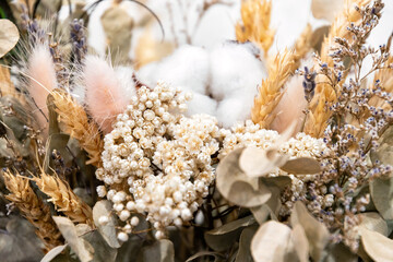 Beautiful dried floral bouquet featuring cotton, wheat, lavender, and eucalyptus. Rustic, natural decor with soft, tones. Perfect for cozy designs © serebryannikov