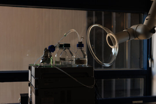 A shadow rich image of a detail of some sort of machine in a chemical lab in a university.