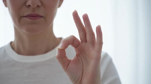 Woman showing the OK gesture for agreement, communication and satisfaction