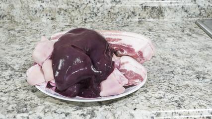 Raw pork liver, belly on plate