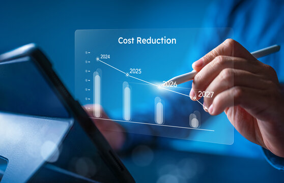 Close up of businessman hand using stylus pen on digital tablet with virtual cost reduction graph. Professional concept for financial optimization, expense management, and corporate budget efficiency.