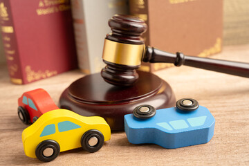 Car accident lawsuit and insurance, Judge hammer with car model.