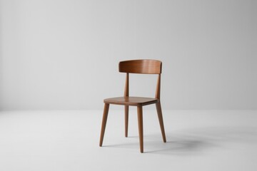 Fototapeta premium Wooden chair with curved back and tapered legs on gray background furniture