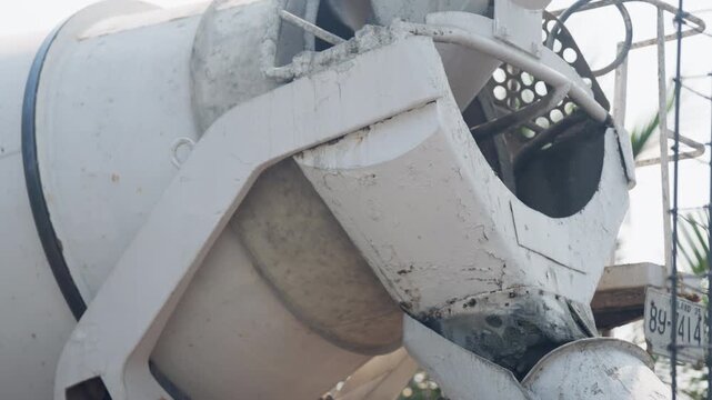 Close-up of concrete mixer truck drum. Industrial cement mixing machine used in construction for transporting and pouring concrete on-site.