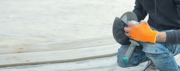 Caucasian worker with an electric grinder.