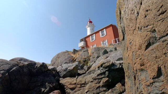 Fisgard Lighthouse Rocky Shore Victoria 4K UHD.Historic Fisgard Lighthouse revealed behind barnacle encrusted rocks. Victoria, British Columbia. 4K UHD
