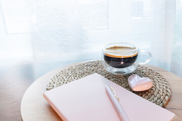 Aesthetic workspace with notebook, coffee and decorative hearts. Perfect for productivity content.