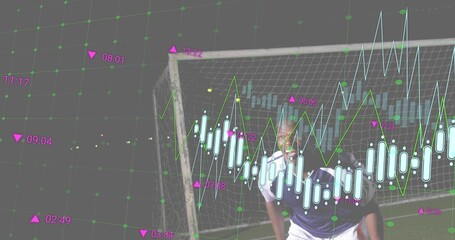Guarding keeper in dark jersey white shorts gloves by soccer goal net showing candlestick charts