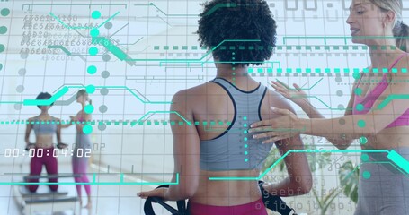 Holding straps client getting trainer adjusting at Pilates studio in sports bra, leggings, teal HUD