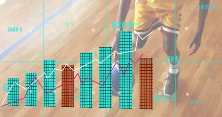 Obraz premium Standing teen player wearing yellow kit holding basketball on wood court showing teal orange charts