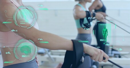 Holding reformer strap, exerciser in sports bra, leggings at pilates studio with AR HUD, copy space