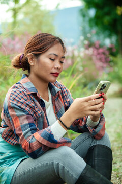 Woman using smart phone in a garden