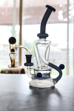 Modern Glass Dab Rig Water Pipe With Blue Accents on Tabletop Indoors for Smoking
