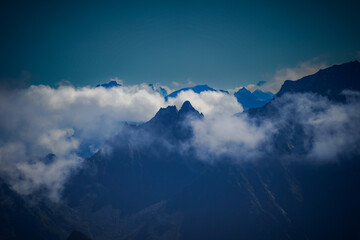 SnowCapped Peaks Emerging From Cloud