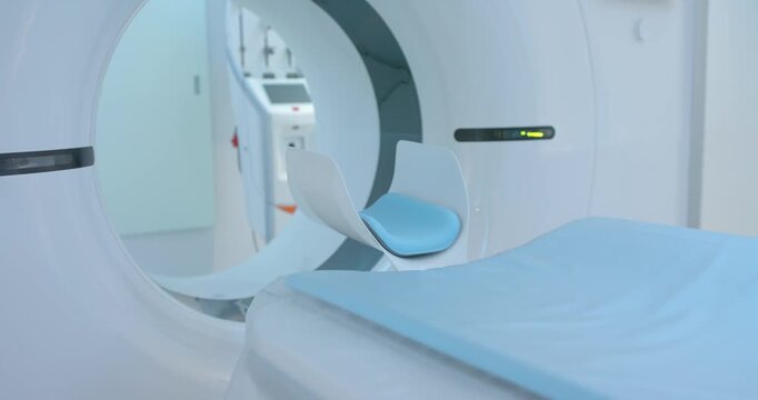 Gantry is shifting couch and head support into bore in radiology as system is starting scan