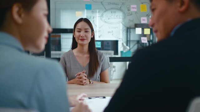 Business,job interview,career and placement concept.back view of two employers sitting and shaking hand of young asian woman,after successful negotiations or interview and Welcome to join in office