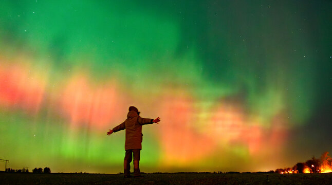 A person looking at Northern lights aurora borealis Lund Skane Sweden 19.01.2026