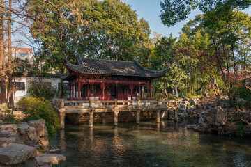 The Nine Lion Study Pavilion on the shore of the pond in the Yuyuan Garden (Yu Garden) on a sunny day, Shanghai, China