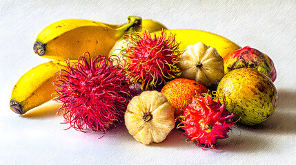 Assorted tropical fruits on white surface