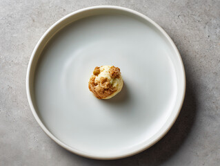 Fine dining dessert with minimalist presentation on white plate