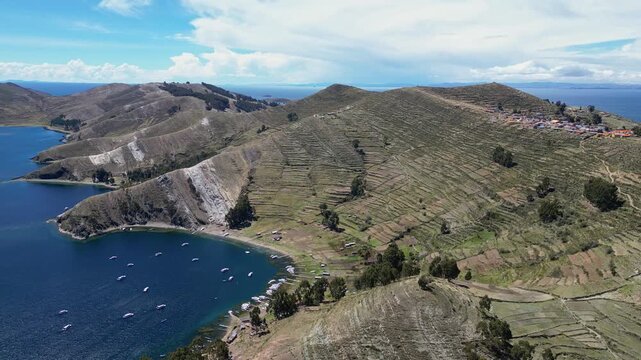 Isla del Sol, Bolivia: Aerial drone footage of the Isla del sol, the sun island with terrace agricultural field and beach along its coastline on the lake titicaca in the Andes in the Bolivia