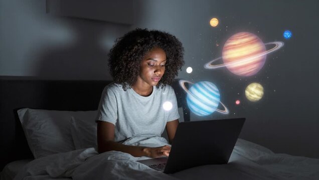 woman sitting bed laptop hands surrounded blanket pillows wall behind object laptop sc