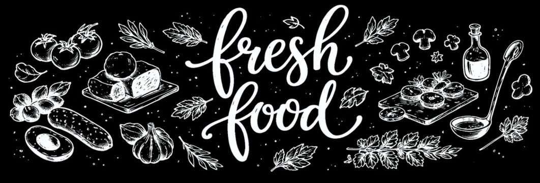 Fresh food white calligraphy lettering with vegetable drawings on black chalkboard background