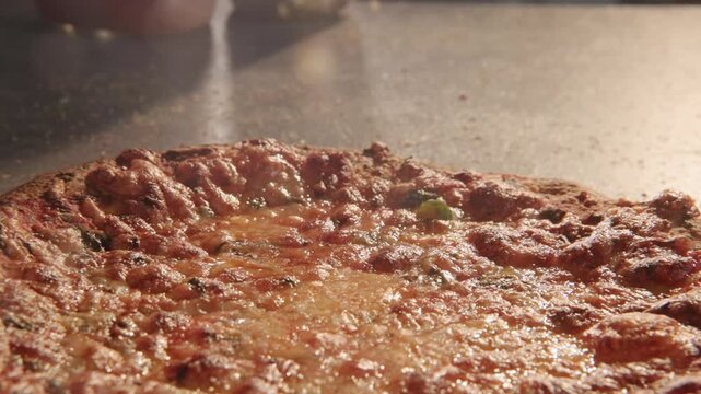 Dolly move sliding overtop overhead greasy unhealthy frozen round pizza pizzas home cooked meal for American families with big bread crusts, marinara sauce, meats, herbs, and lens flare in slow motion