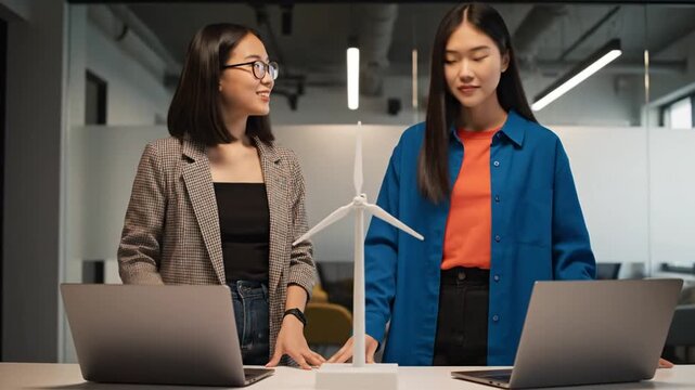 Young women with windmill model.