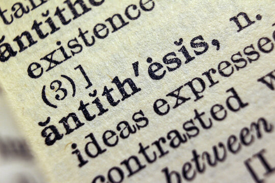 Word antithesis printed on dictionary page, macro close up