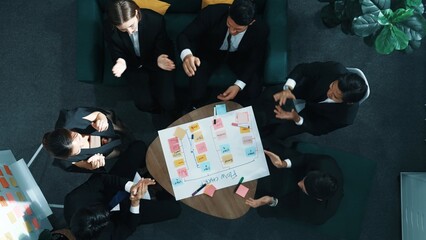 Top down view of business people hands making scrum task board to manage workflow in workplace....