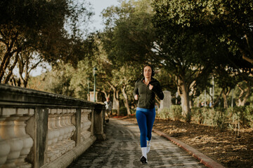 Woman runs along a path in Malta during morning exercise routine