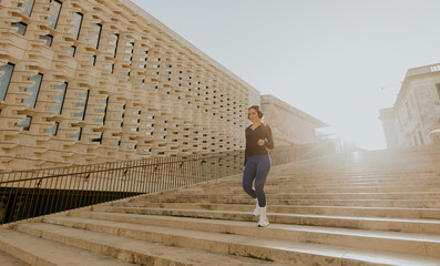 Woman exercises on steps in Malta during daylight hours
