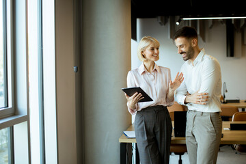 Discussion between coworkers in modern office during the morning hours