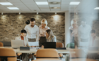 Team collaboration in a modern office space focused on a shared project during the day
