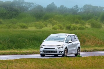 Fototapeta premium Shiny MPV vehicle driving on rural freeway landscape
