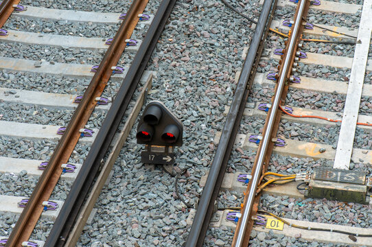 close up of a railway track showing a ground shunting signal placed between the tracks